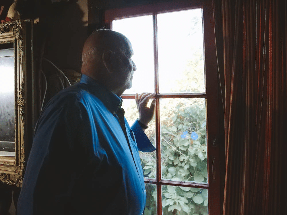 Man Looking Out the Window