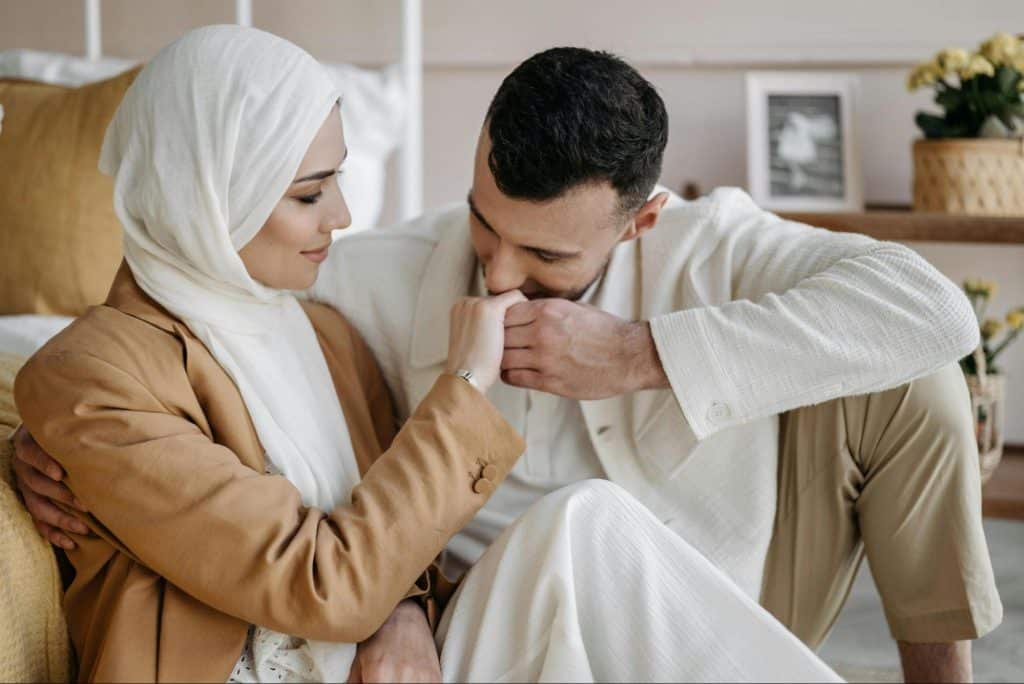A man kissing a woman’s hand