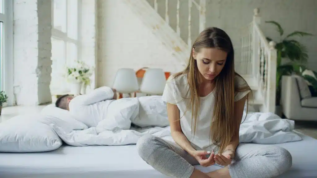A woman looking sad at home