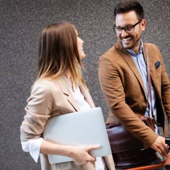 A man and a woman smiling confidently while walking