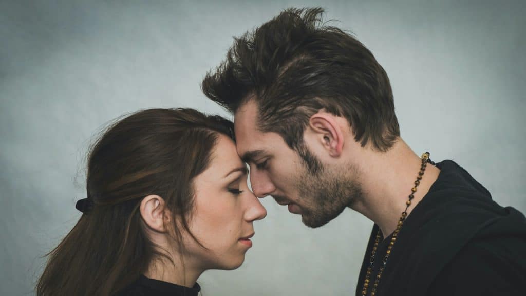 Man and woman touching foreheads.