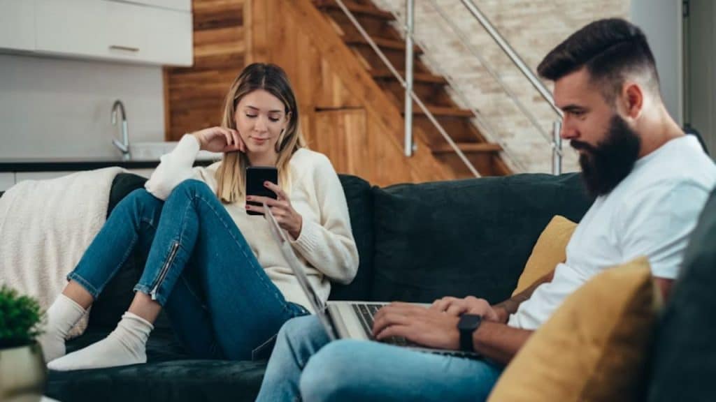 Couple sharing space but showing emotional disconnection