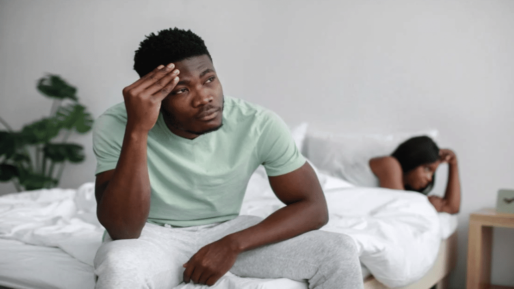 A couple looking sad in bed