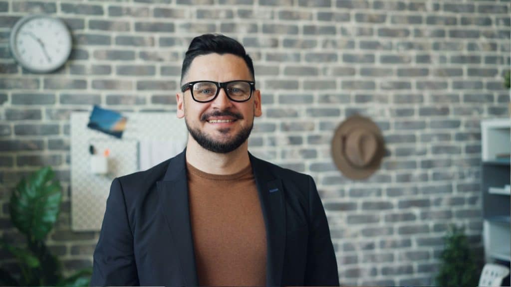 A smiling mature man wearing glasses.