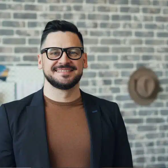 A smiling mature man wearing glasses.