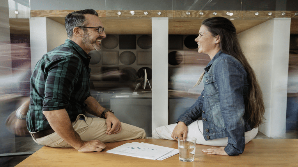 A couple smiling at each other in the office
