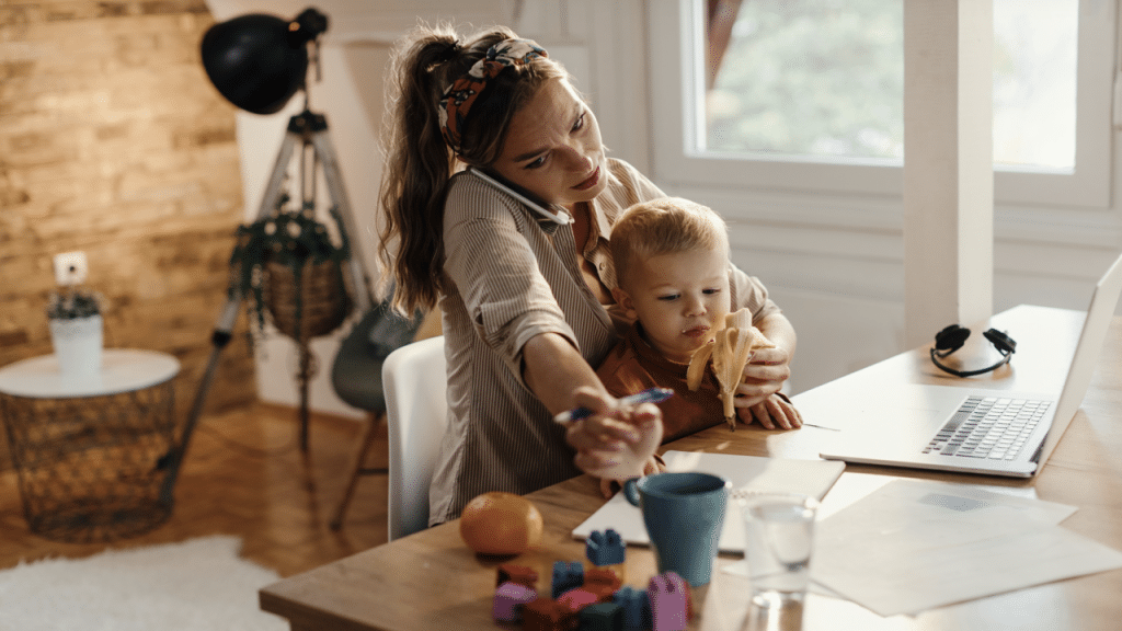 A mom working while feeding her son