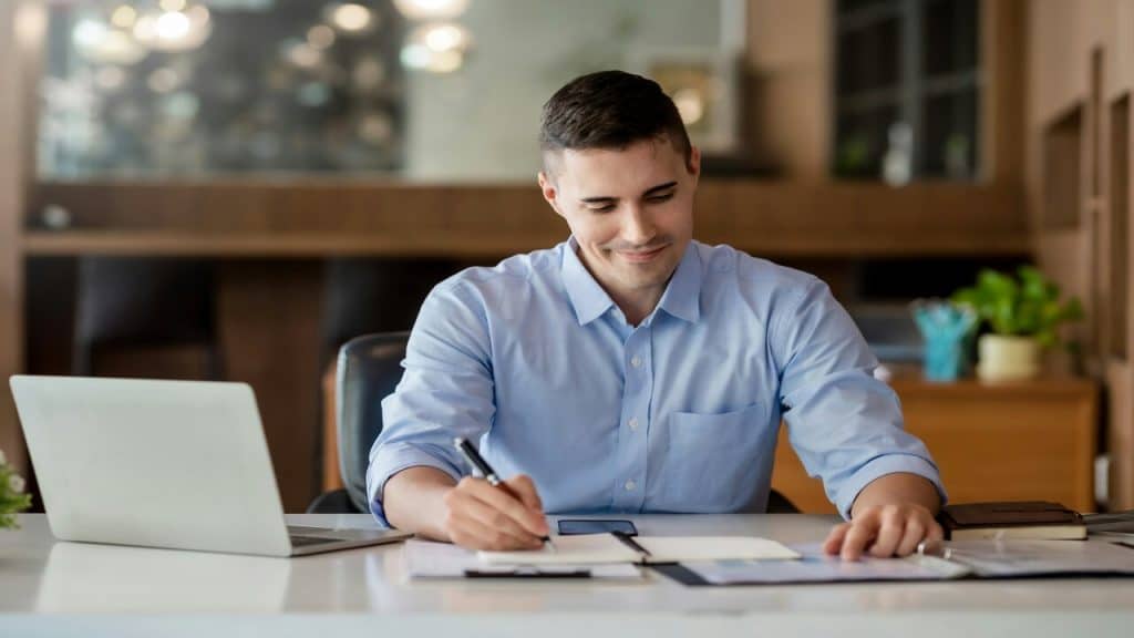 A man taking notes while studying