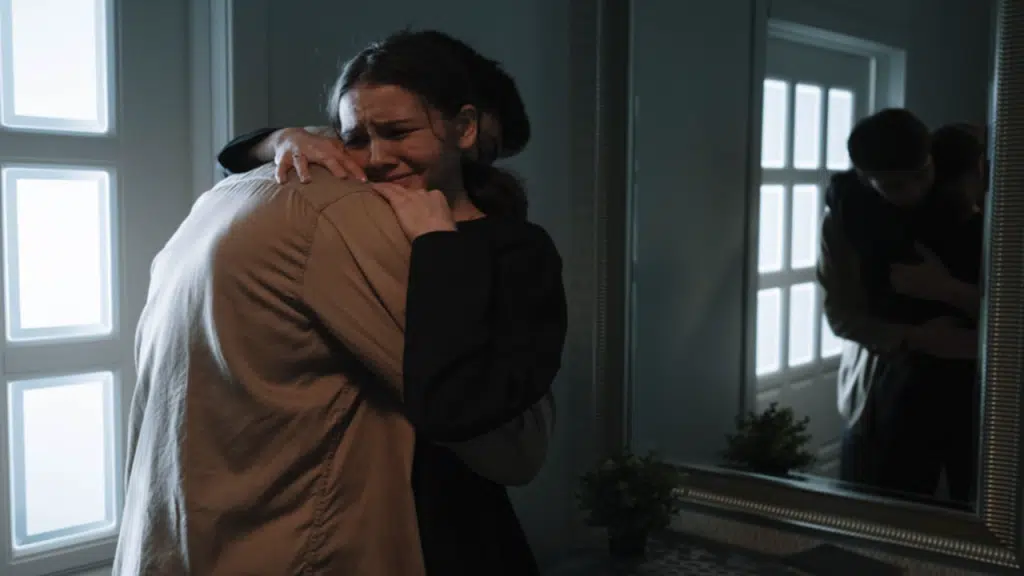 A man comforting his crying wife