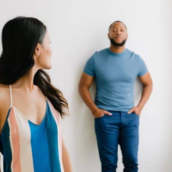 Man reflecting silently as his partner speaks in the background
