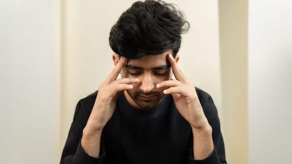 Man taking a deep breath while reflecting quietly.