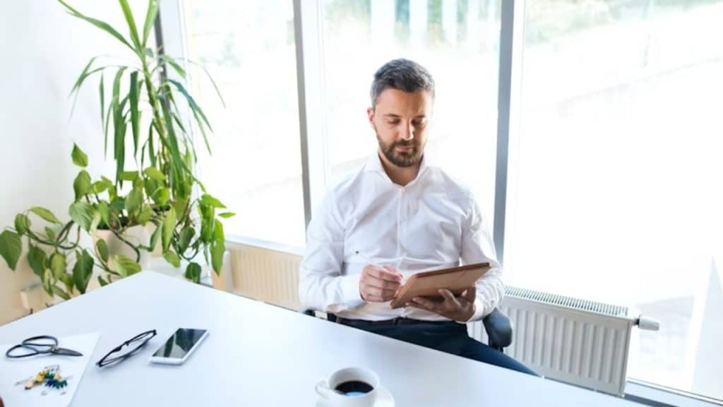 Man journaling in a quiet café