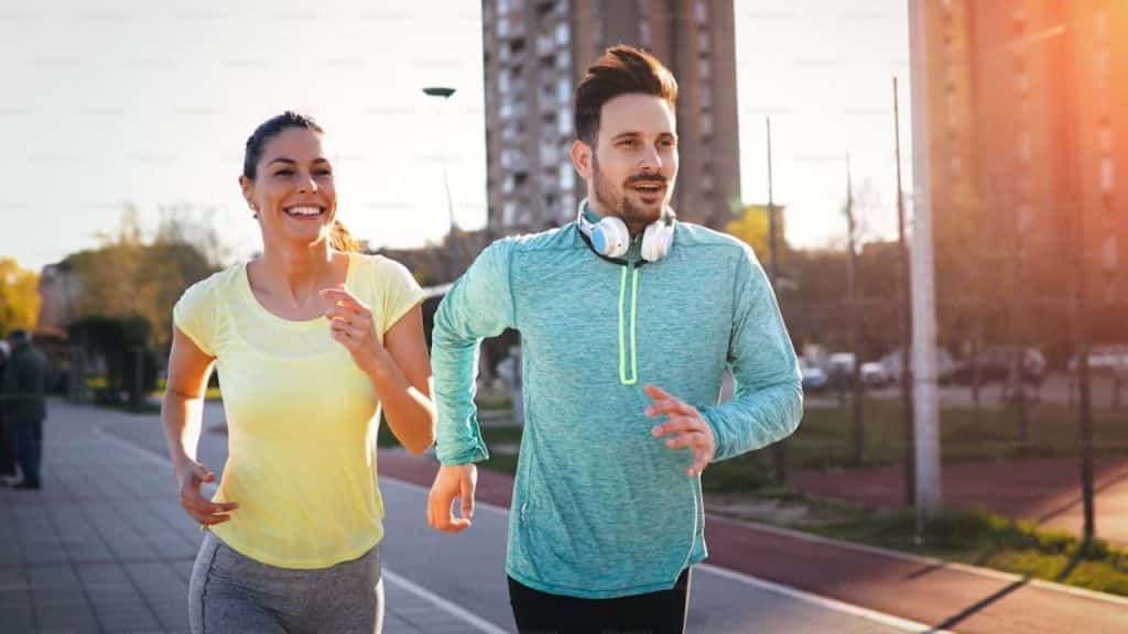 Couple running outdoors, building health and partnership