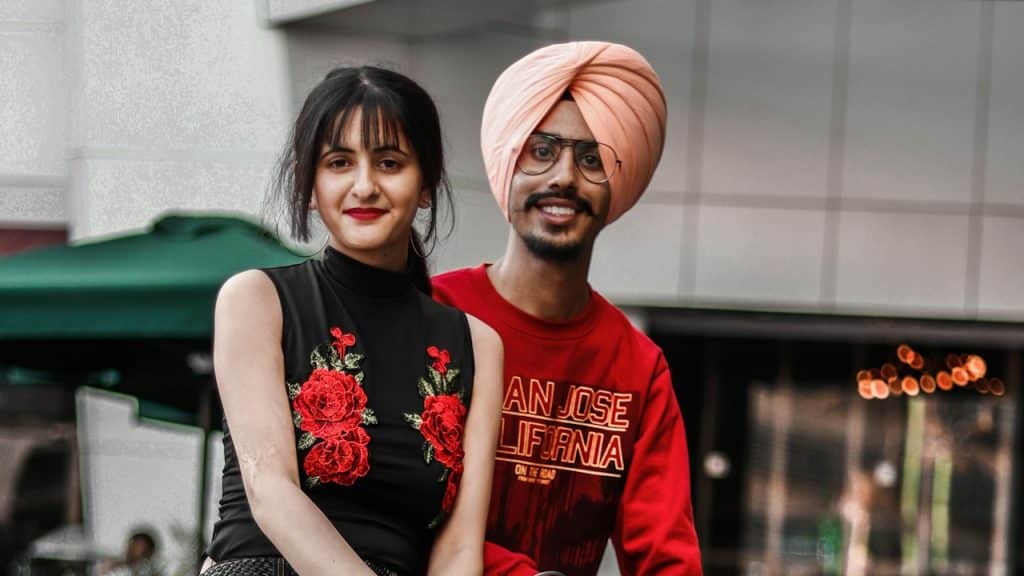 A couple posing for a picture outdoors. 