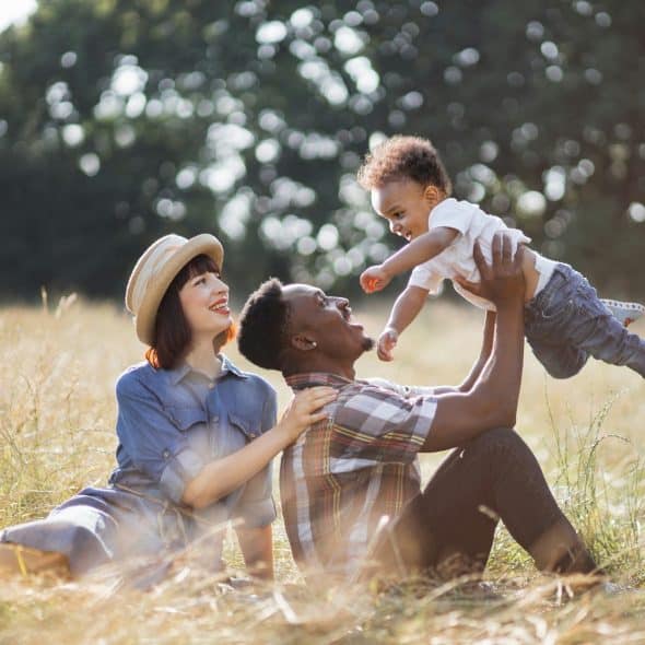 The family is spending time with each other on the field.