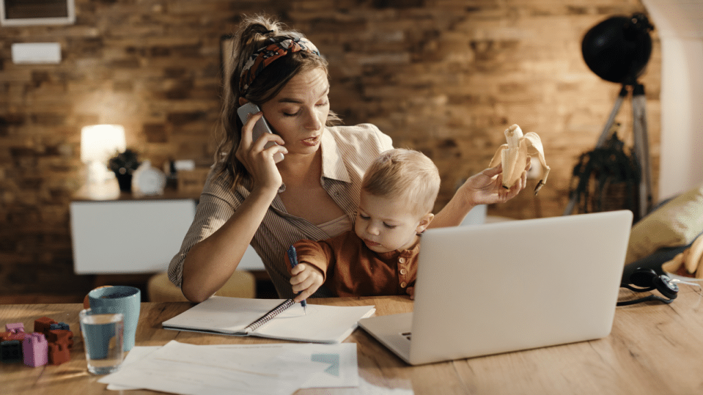 A woman working while taking care of her baby