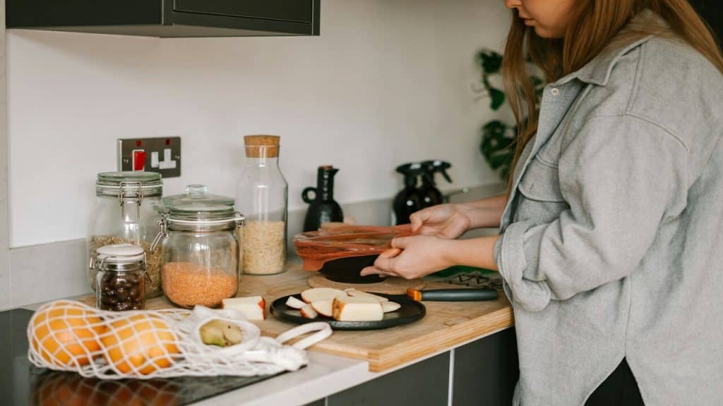 A woman preparing food by herself