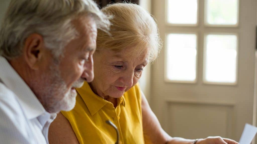 A senior couple is managing monthly expenses.