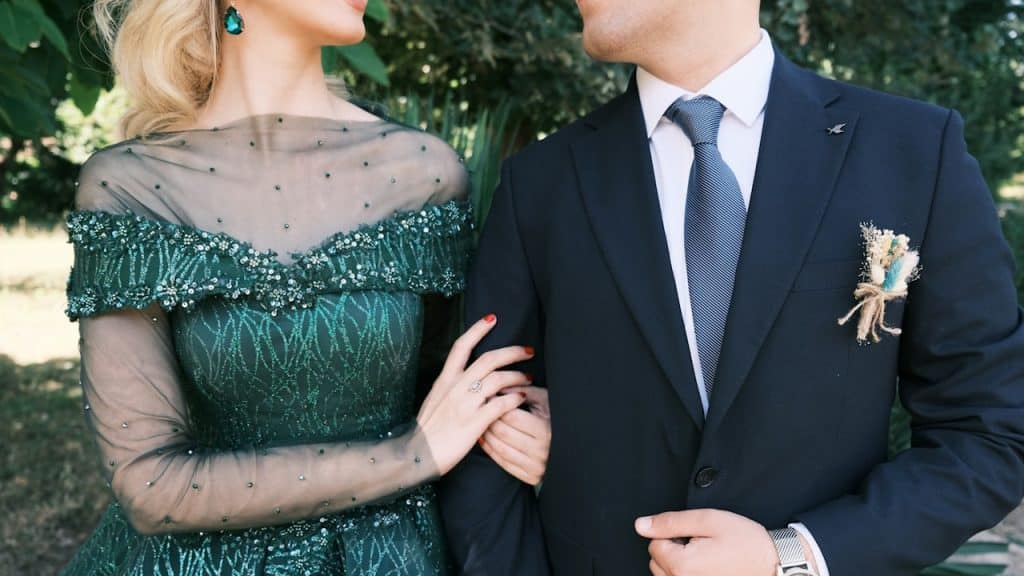 A man in a suit and a woman in a green dress.