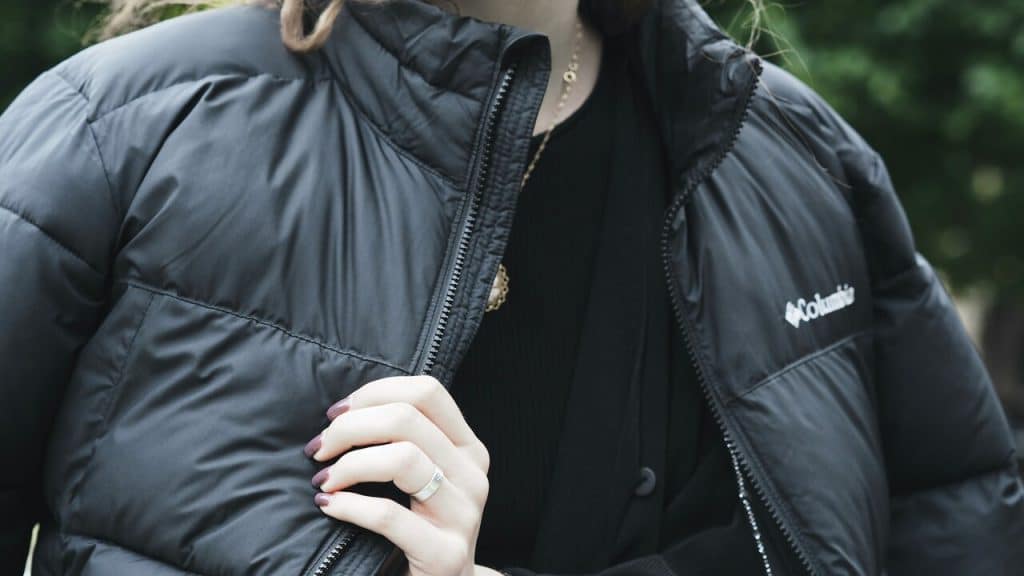 A woman with a big jacket over her shoulder