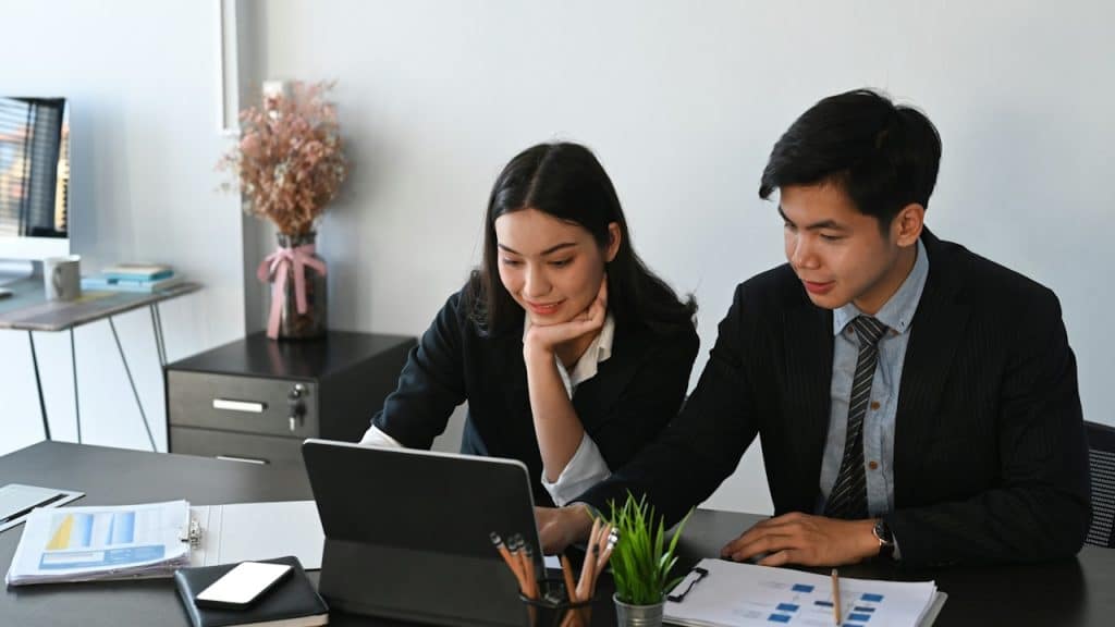 A couple analyzing accounts while sitting at a table