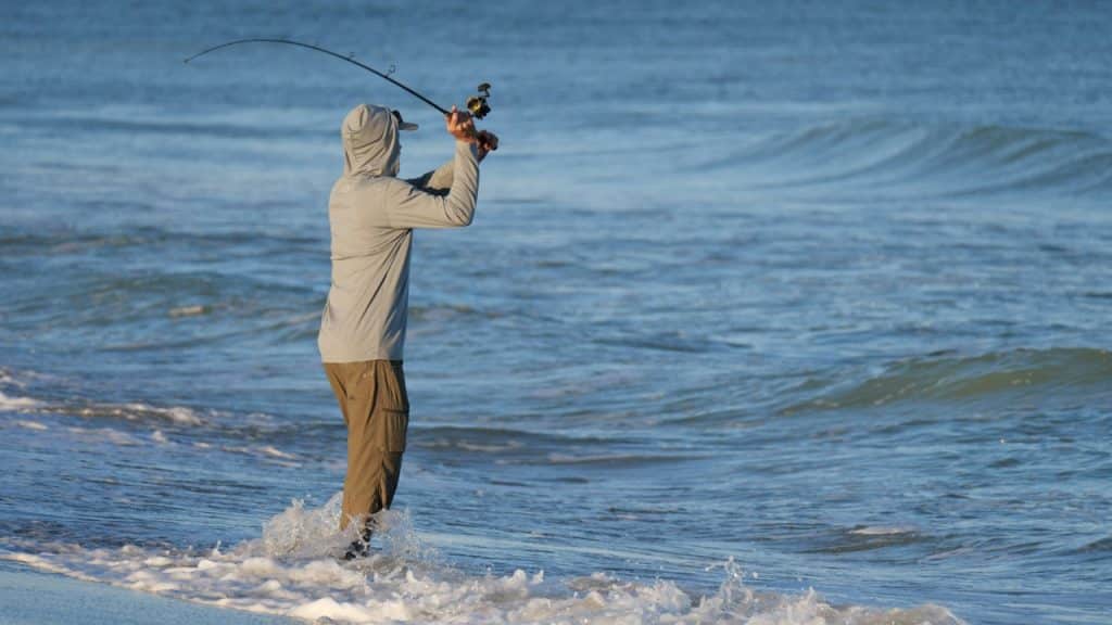 A man fishing at the beach.