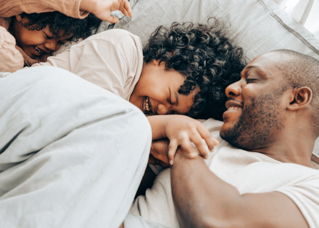 Happy children playing with dad