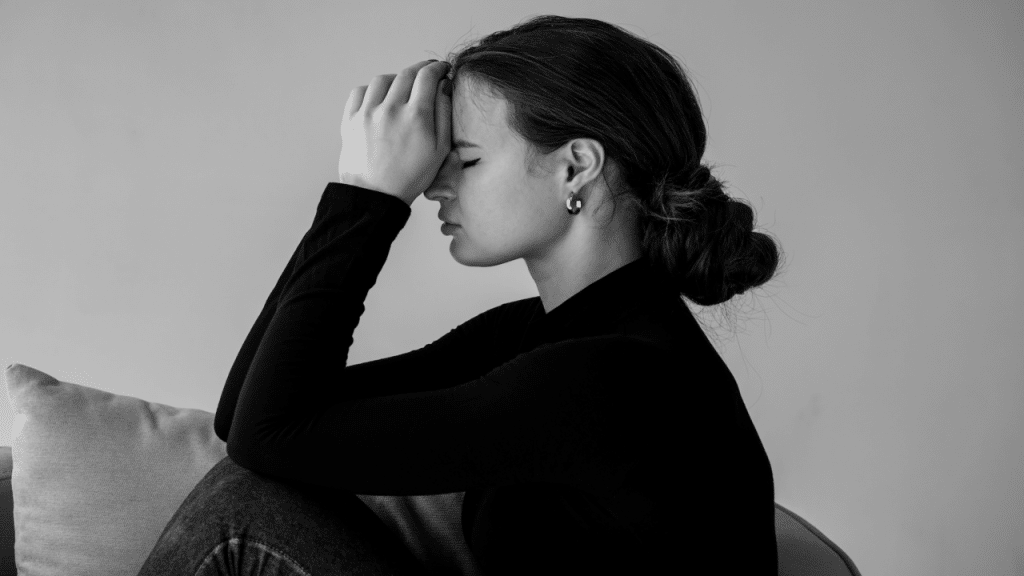A woman looking sad at home