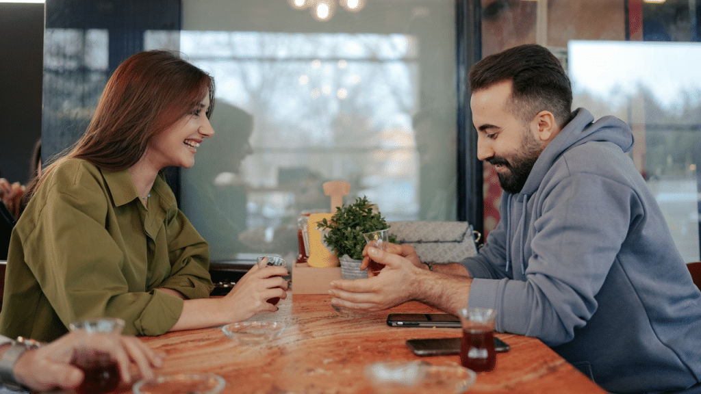 Friends smiling at each other at a table