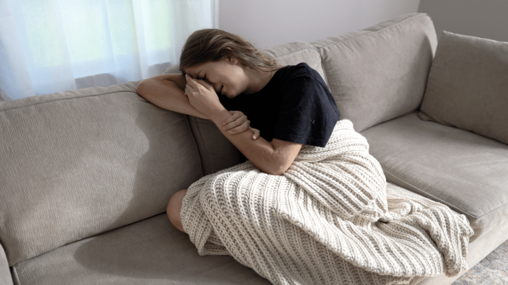 A woman crying on the sofa