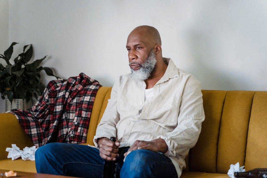 Man in Beige Button Up Shirt Sitting on Yellow Sofa