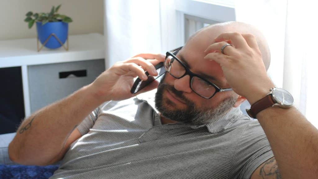 A man looking upset while on the phone