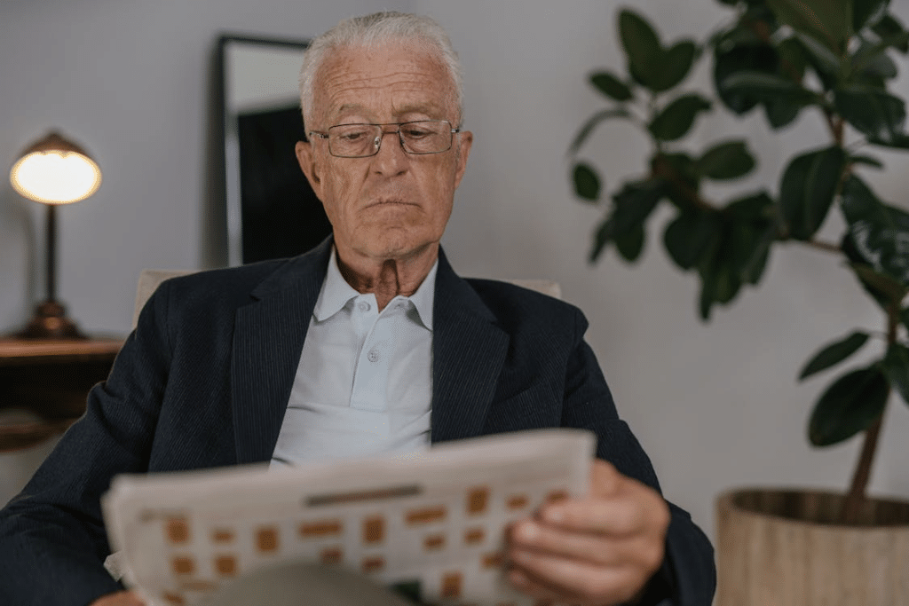 Man in Black Suit Jacket Wearing Eyeglasses Reading
