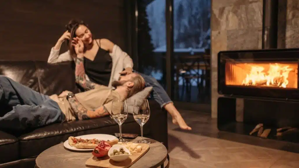 A couple holding each other while sitting on a sofa