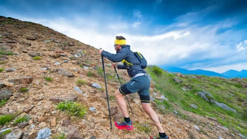 Man hiking a steep trail with focus and determination