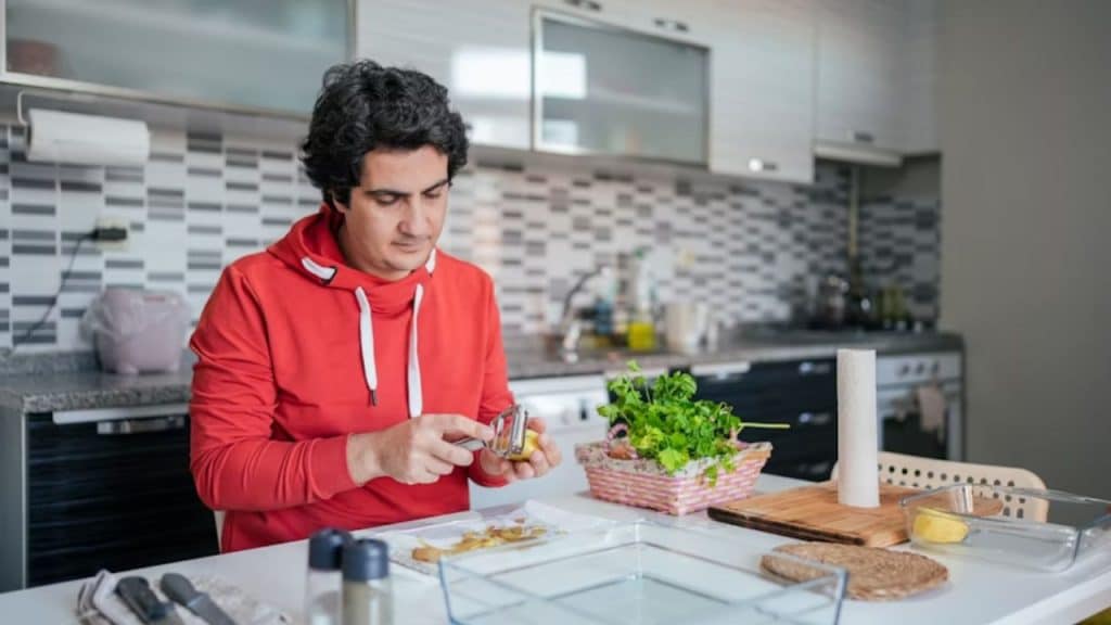 Man cooking dinner for his partner at home