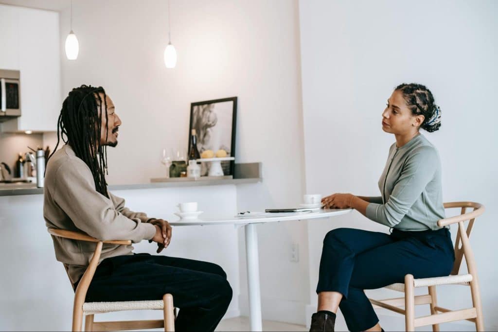 A man listening to a woman