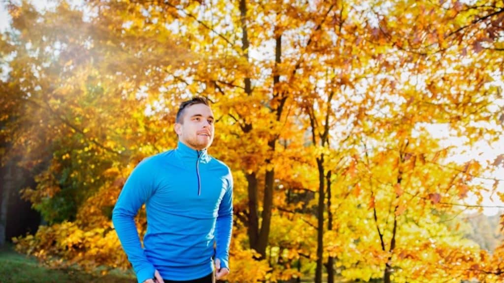 Man jogging in a park during autumn