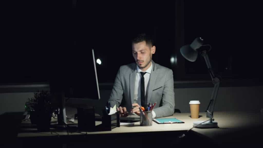 Man in office late at night looking exhausted