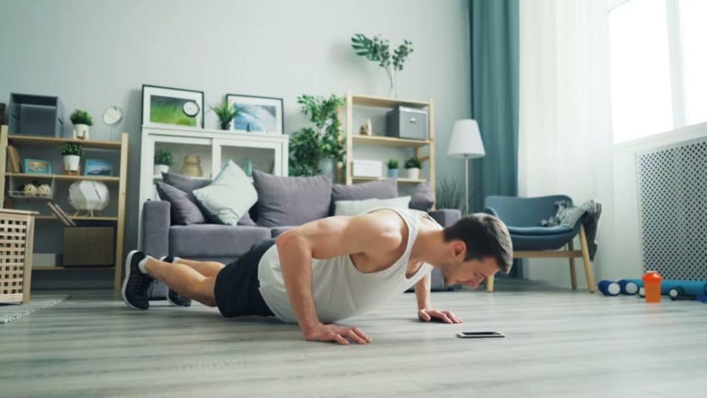 Man doing push ups in his living room.