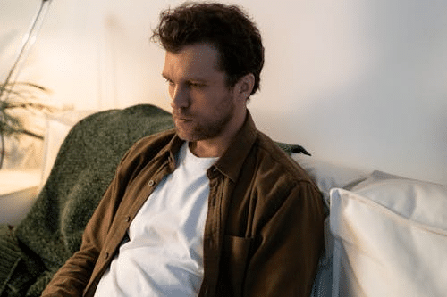 A Sad Man Sitting on a Sofa