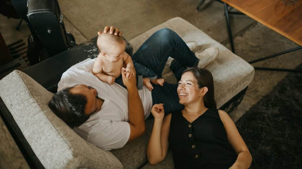 A couple playing with their baby.