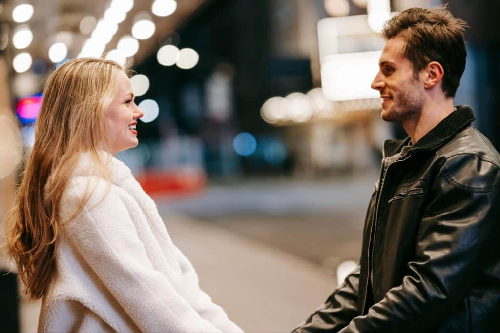 A man and woman facing each other