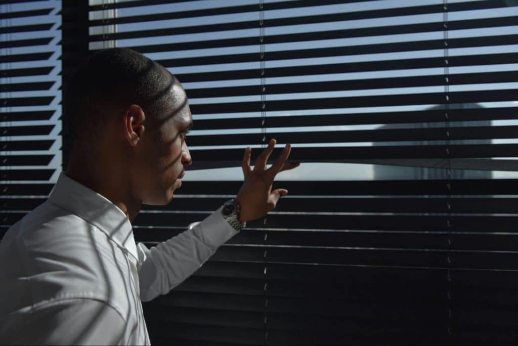 A man looking outside his window
