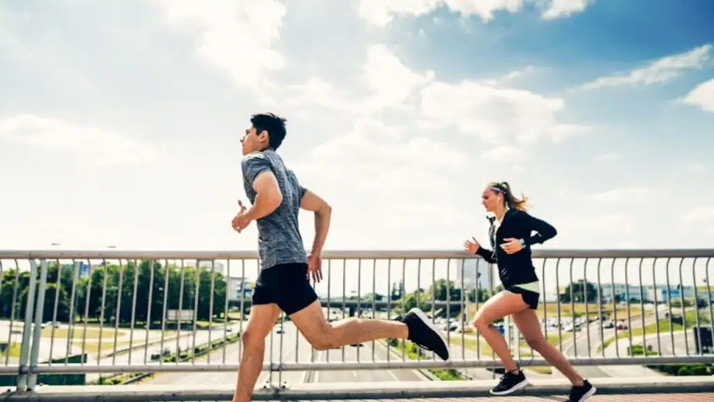 A man jogging ahead of his partner, leaving her behind