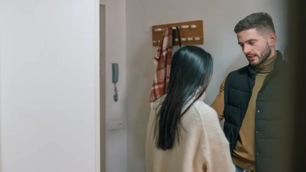 A couple having a serious talk by the entryway