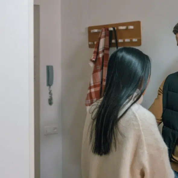 A couple having a serious talk by the entryway