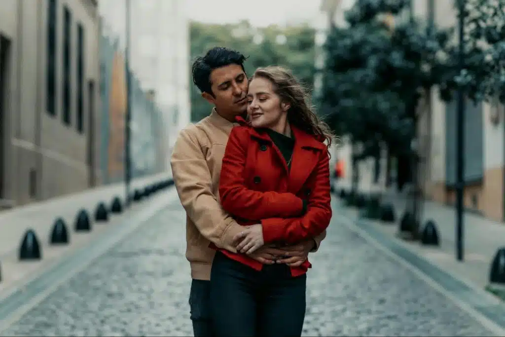 A man hugging a woman behind