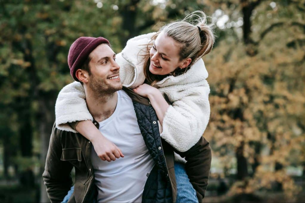 A man carrying a woman on his back