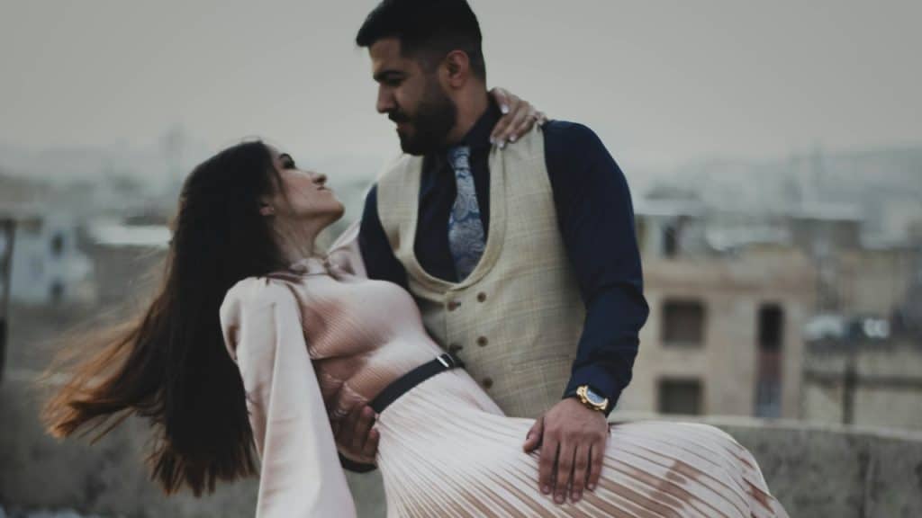 A man and a woman dancing on a rooftop.